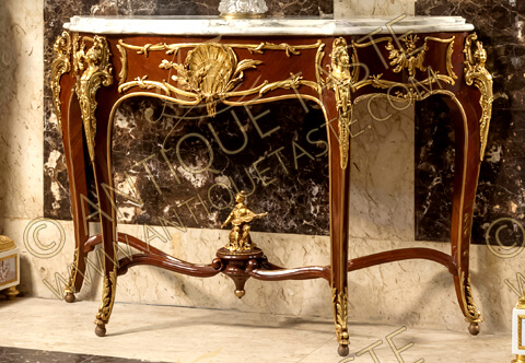 Our breathtaking Belle Epoque Royal masterpiece reproduction of Francois Linke and Leon Message Circa 1905 Louis XV style ormolu-mounted and veneer inlaid freestanding Console Table; with a beveled serpentine marble top above an undulating frieze centered by a coquille and cascading water, on cabriole legs headed by alternating male and female busts, the tapering lets joined by a serpentine stretcher surmounted in the center with an ormolu musician; the whole piece is adorned with ormolu filet and acanthus leaves and resting on ball feet topped by acanthus leaves